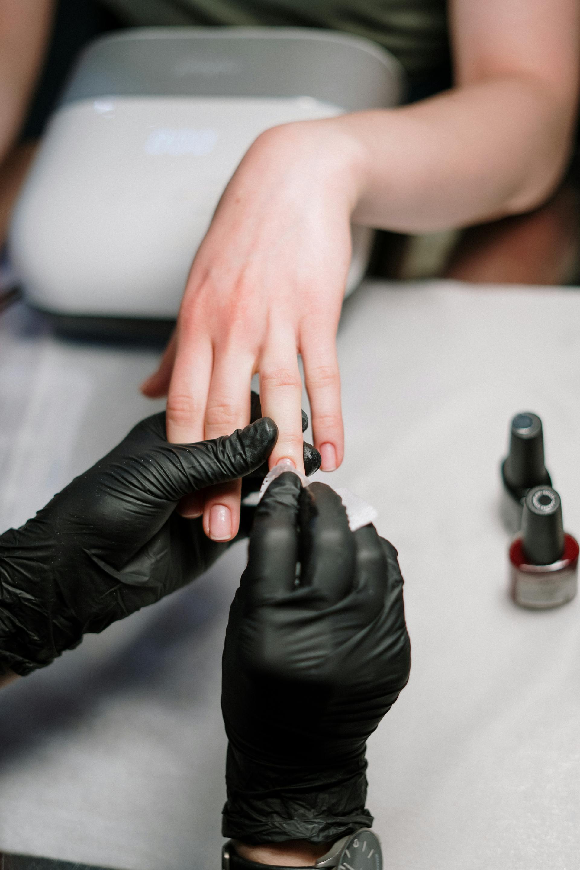 woman in salon getting manicure